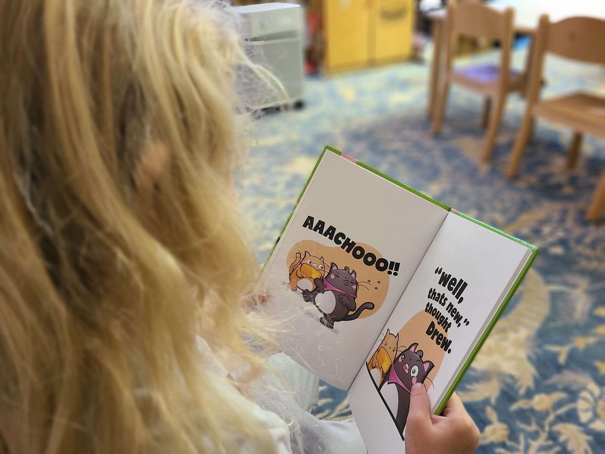 Child reading a FRENS book